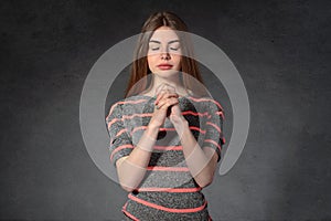 Woman shows calmness against a dark background