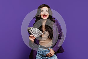woman shows fan of cash money