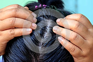 Woman shows her gray hair roots