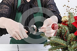 Woman shows how to make Christmas decoration with the poinsettia flower