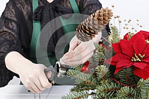 Woman shows how to make Christmas decoration with the poinsettia flower