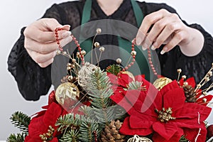 Woman shows how to make Christmas decoration with the poinsettia flower