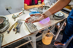 Woman shows precious stones (moonstone) in mine