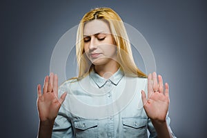Woman shows the stop arm isolated on gray background. photo