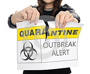Woman shows and tearing paper with Covid-19 lockdown quarantine outbreak alert words. The idea or concept for the ending,