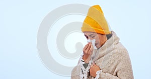 Woman, sick and flu with tissue, fever and blanket for cold, blue studio background and illness. Blowing nose, virus and