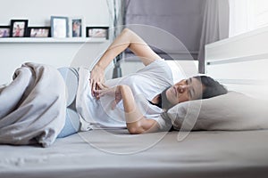 Woman sick and having painful stomachache, female period cramps