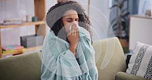 Woman, sick and sneeze at home, sofa and blanket to relax, recover and keep warm from winter season. Female person, flu