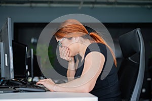 A woman is sick and sneezes at the desk in the office photo