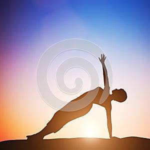 Woman in side balance yoga meditating at sunset. Zen