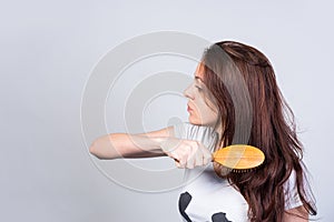 Woman in Side View Brushing her Long Hair