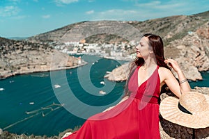 A woman, a side view in a red flying dress fluttering in the wind, a girl in a fluttering dress on the background of the
