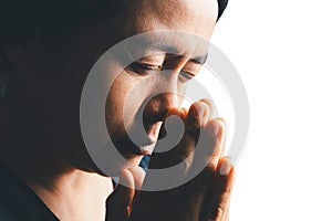 Woman side who believes in god, person hands praying on isolated white background. Asian woman stands in meditative pose, holds