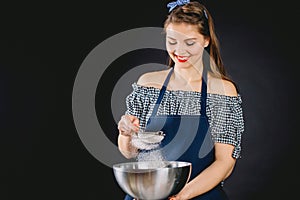 Woman sifting flour through sieve.