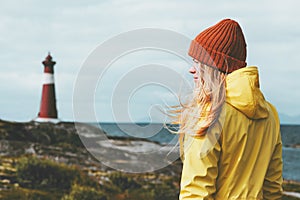 Woman sightseeing lighthouse sea landscape in Norway Travel Lifestyle concept scandinavian vacations outdoor