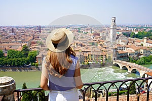 Woman sightseeing Verona city landmarks vacations in Italy travel lifestyle girl tourist relaxing at viewpoint Old Town aerial