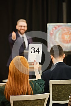 Woman with sign at auction