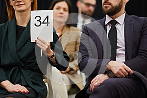 Woman with sign at auction