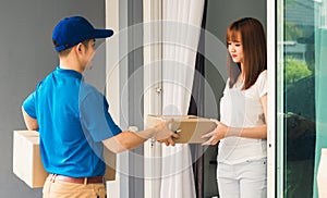 Woman signing delivery in clipboard get her package from service courier man