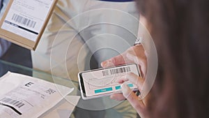 Woman signing delivery receipt on smart phone device