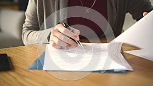 Woman signing documents