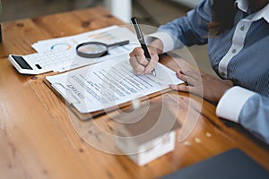 Woman signing rental contract at meeting with realtor or landlord, Property purchase, mortgage and loan ownership