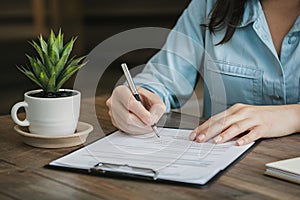 Woman signs car insurance or lease paper with keys