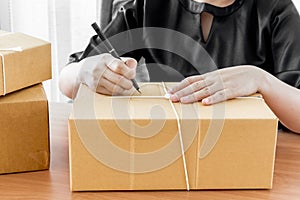 Woman signs papers among parcels