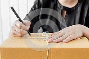 Woman signs papers among parcels