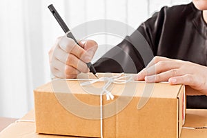 Woman signs papers among parcels