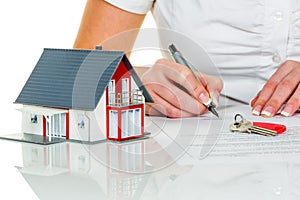 Woman signs purchase agreement for house