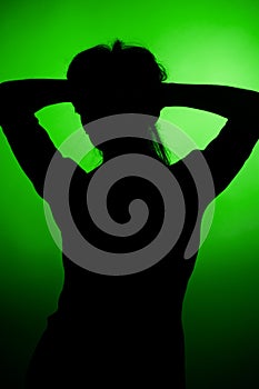 Woman silhouette on green background