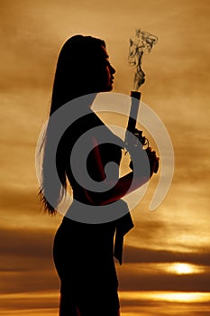 Woman silhouette gun smoke