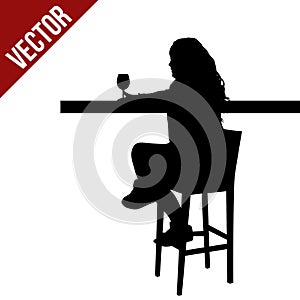 Woman silhouette sitting at a table in the cafe, bar, restaurant or pub