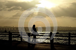 Woman silhouette at sunset