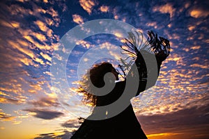 Woman silhouette sunset sky sleeves flight fringe