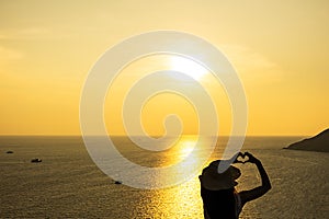 Woman Silhouette at Windmill viewpoint in summer Phuket