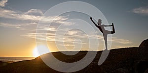 Woman, silhouette or yoga on sunset beach rocks in relax fitness, training and exercise for mental health, body mobility