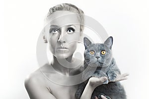 Woman with silver makeup on face holding gray cat