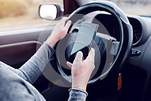 Woman simultaneously driving car and reading text message photo