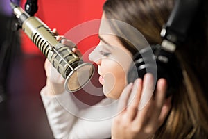 Woman singer face singing in a radio show