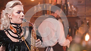 Woman singing a great song on saxophone in a club