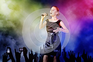 Woman singing for her fans on a concert