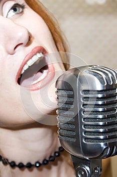 Woman singing into microphone