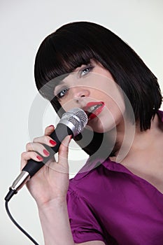 woman singing in microphone