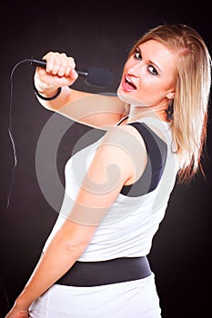Woman singing rock song microphone