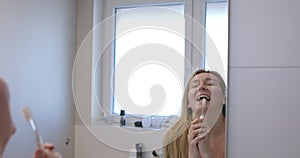 Woman singing with toothbrush