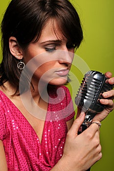 Woman Singing into Vintage Microphone