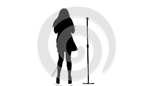 Woman sings incendiary songs into the microphone. White background. Silhouette