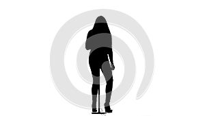 Woman sings incendiary songs into the microphone. White background. Silhouette. Slow motion